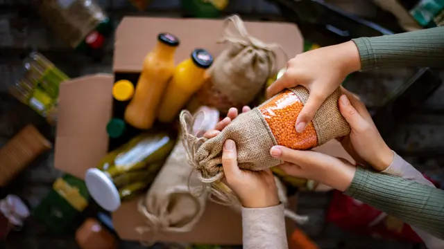 Two people holding a food donation Two people holding a food donation
