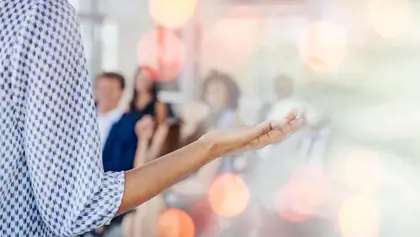 Speaker's hands gesturing towards audience Speaker's hands gesturing towards audience