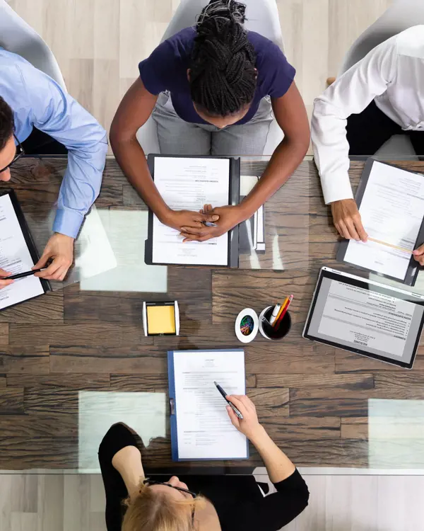 People working together in an office People working together at a table in an office