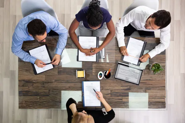 People working together in an office People working together at a table in an office