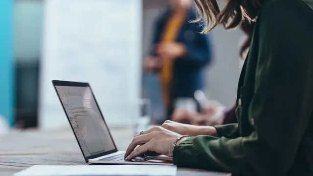 Person working at a laptop. Person working at a laptop.