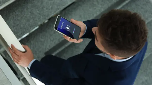 Man using the voice function on his cell phone Man using the voice function on his cell phone