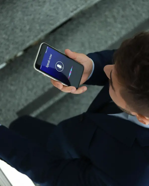 Man using the voice function on his cell phone Man using the voice function on his cell phone